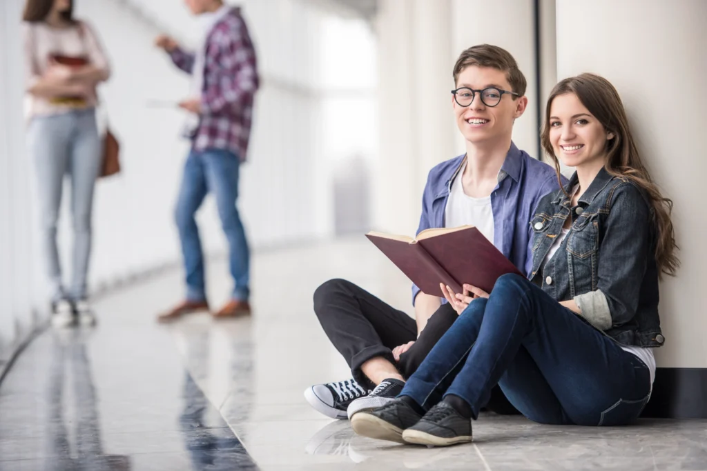 couple students sitting reading book
