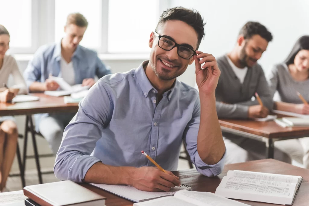 guy smiling while making notes
