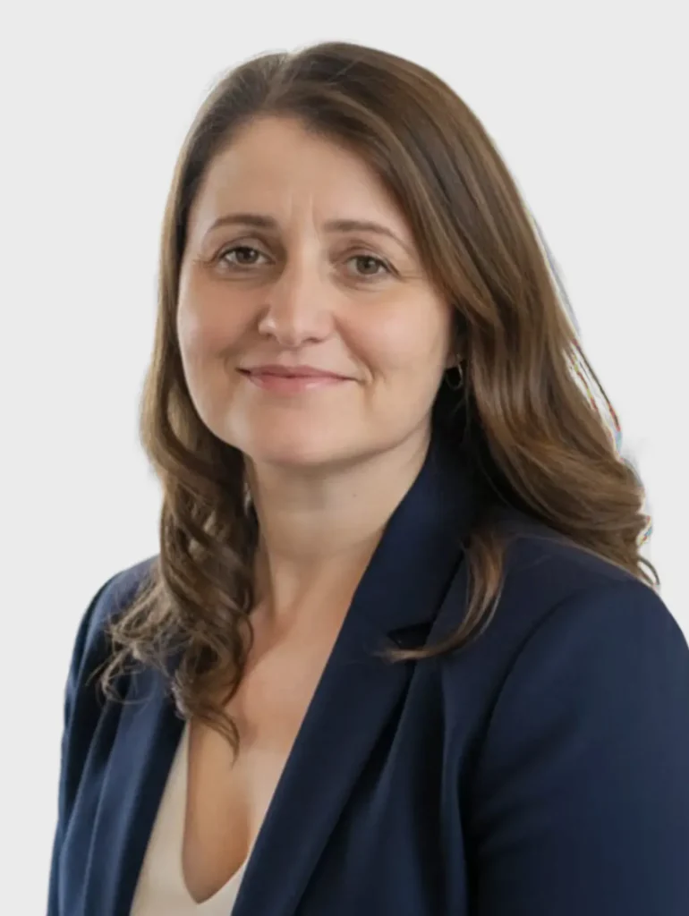 Femeie zâmbind, îmbrăcată în sacou albastru